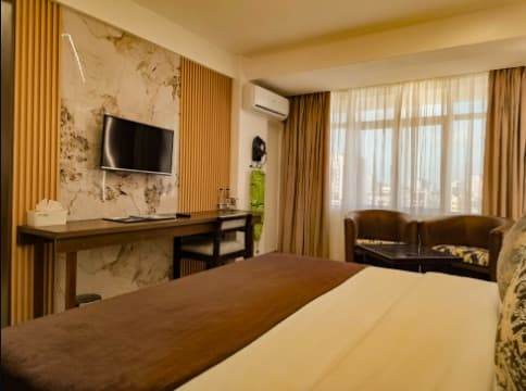 Hotel Sapphire bedroom with city-facing windows