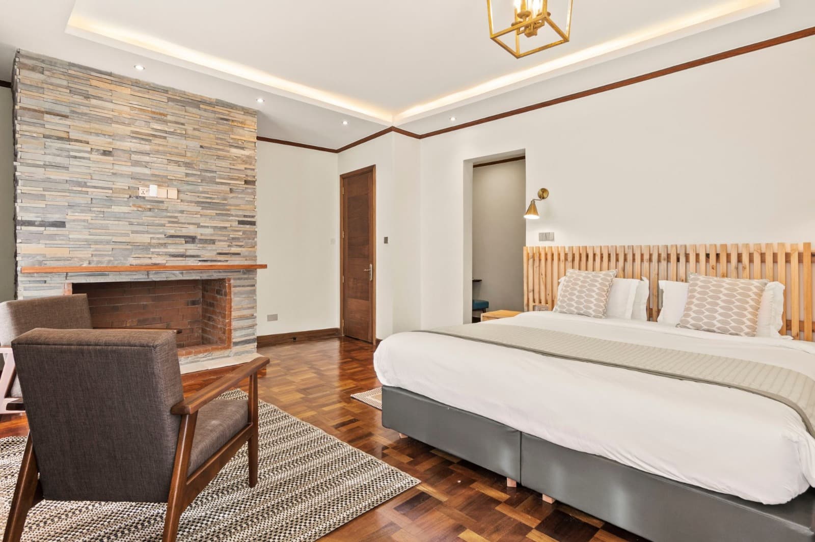 Kirimara Woodlands bedroom with fireplace and king bed
