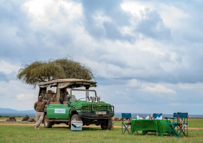 Mutara Camp safari vehicle and bush dining setup in Laikipia