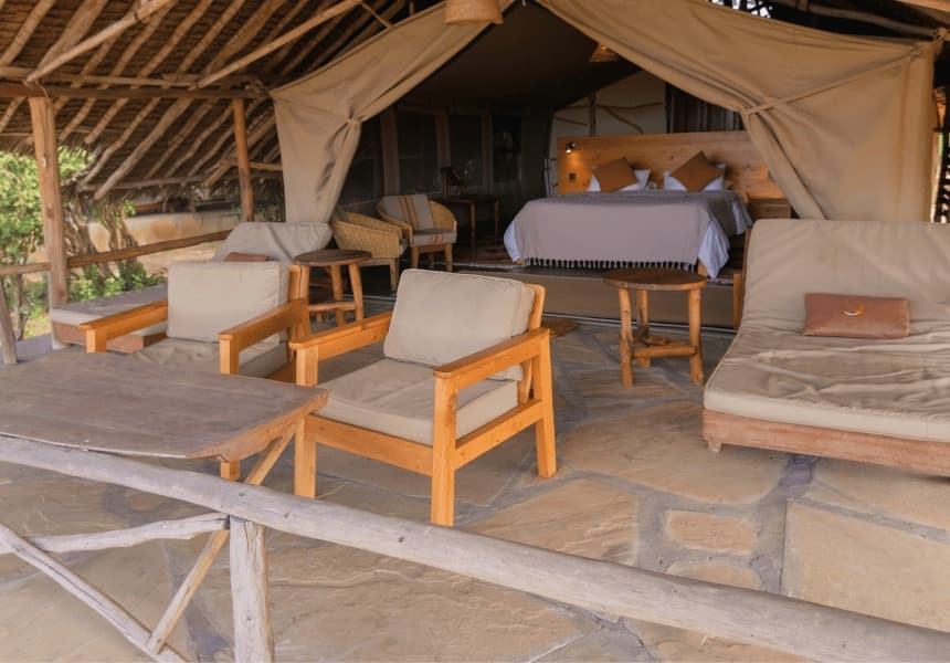 Satao Camp tented room with bed and lounge seating